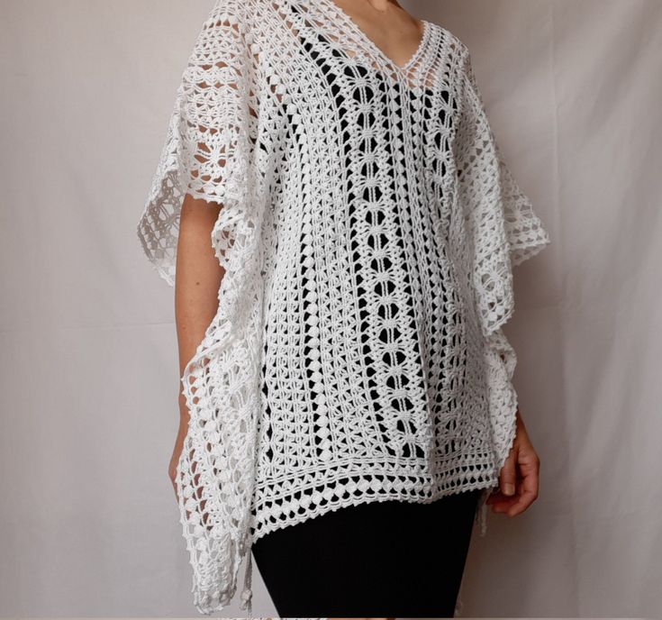 Beach lace tunic, white color, made of mercerized cotton. The pattern gives a nice ethnic look. The width is adjustable, as there are two strings on both sides (Romanian cord made also by hand) of the same thread. It can be worn as a short caftan, a beach dress, or swimsuit cover up. The cotton and the lace pattern give a pleasant cooling effect, helping to enjoy the summer days.  Made in smoke free, pet friendly environment.  Length: 27'' or 68 cm Width: 31'' or 78 cm Neck opening depth: 7.5'' White V-neck Crochet Dress For Beach, White Crochet Bohemian Cover-up, White Crochet Beach Cover-up, Bohemian White Crochet Dress For Beach Season, White Crochet Cover-up For Vacation, White Crochet Beachwear Top, White Crochet Lace Beachwear Cover-up, White Crochet Lace Beach Cover-up, White Crochet Beach Dress For Beach Season