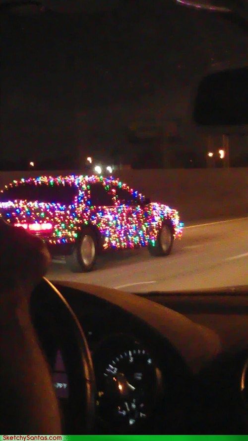 a car driving down a street with christmas lights on it's dash board and dashboard