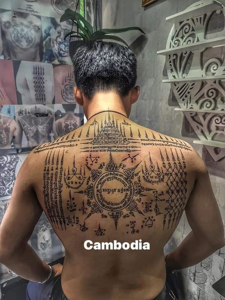 the back of a man with tattoos on his body