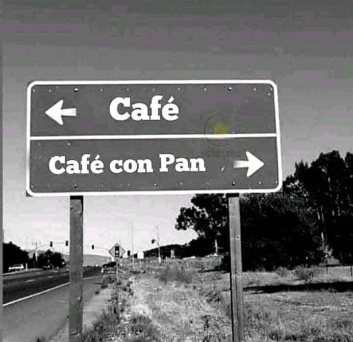 a black and white photo of a road sign with the words cafe on pan above it