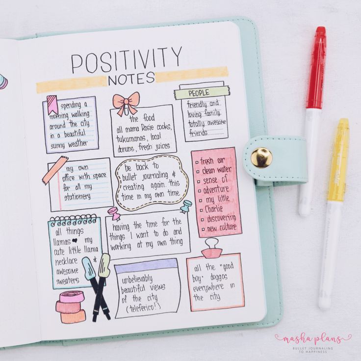 an open notebook with writing on it next to two markers and a pen, which is also labeled positivity notes