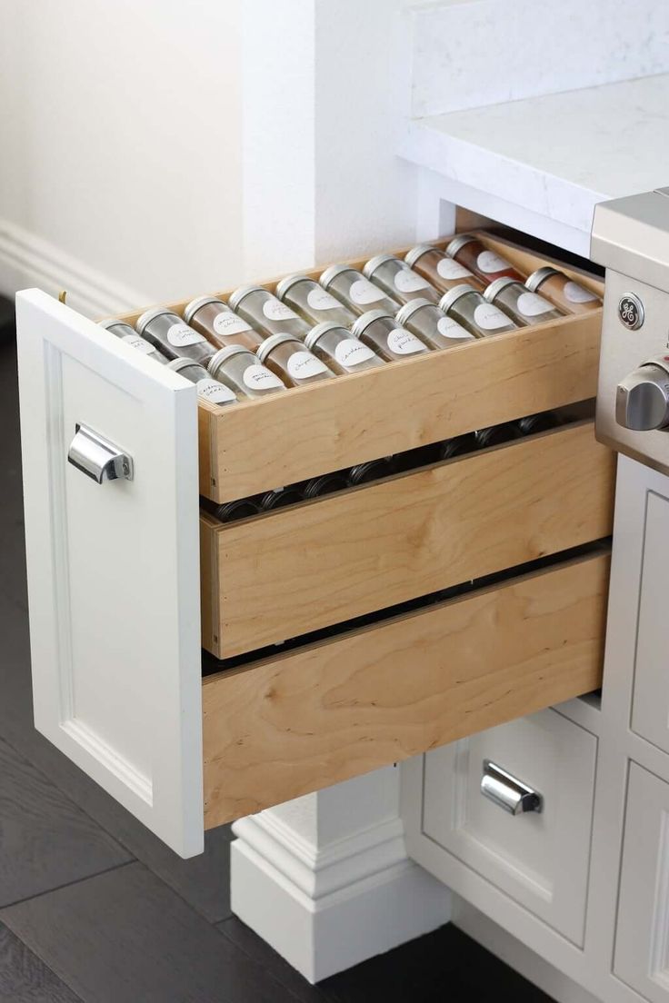 an open drawer in the middle of a kitchen