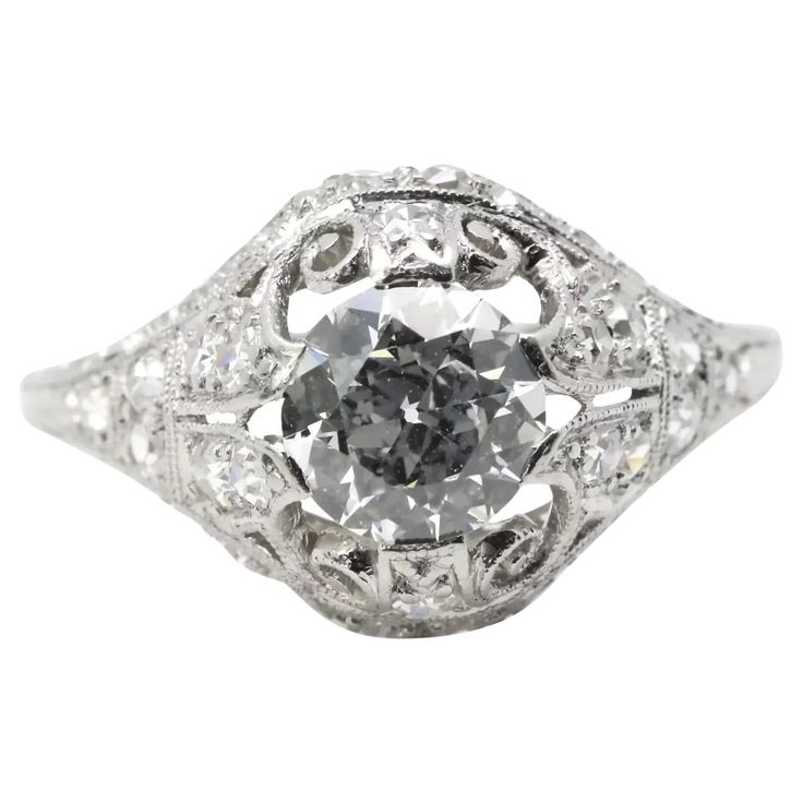 an antique style diamond ring with filigrees