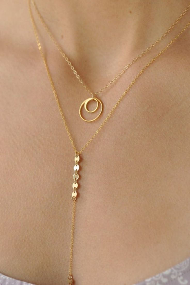 This is a show stopper lariat necklace. Its dainty and sparkly chains are beautiful layered with other favorites. This is definitely a piece you should have in your jewelry collection!! Our gift to you 10% off your first purchase. Details here - http://eepurl.com/dpVPBz DETAILS Chain drop is approximately 3 3/4" long Super sparkly dainty chain and sequin/disc chain 14 k gold fill or sterling silver chain and components Length choice from 15" to 24" Delicate 14k Gold Filled Lariat Jewelry, Delicate 14k Gold Filled Charm Necklaces For Layering, Dainty Sterling Silver Lariat Necklace, Yellow Gold Lariat Necklace For Layering, Dainty Lariat Charm Necklace For Everyday, Adjustable Dainty Lariat Necklace, Gold Double Strand Lariat Necklace For Layering, Adjustable Dainty Lariat Necklace For Layering, Adjustable Gold Lariat Necklace For Layering