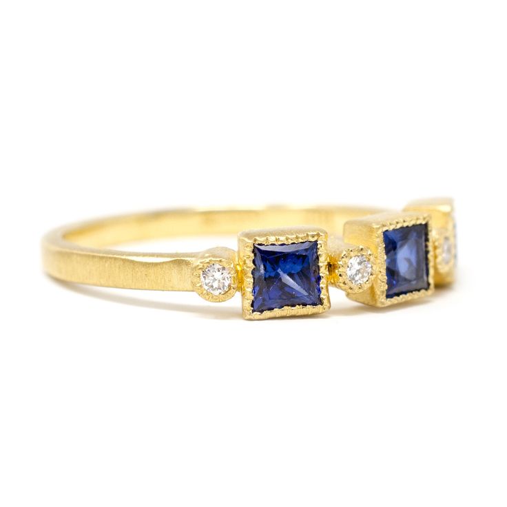 You'll be seeing triple with this deco-inspired triptych of sapphires accented by diamonds. This 18k gold ring features three french cut sapphires complemented by round full cut white diamonds all set in single milgrain. Pictured in:18k yellow gold1.07ctw french cut sapphires.04ctw white diamonds1.5mm wide band Jennifer Dawes Design works with responsible diamantaires. Due to fluctuations in the diamond market, pricing varies on diamonds based on color and clarity. Please contact us and we will Three Stone Sapphire Ring, Bridesmaid Brunch, Wedding Lookbook, Emerald Wedding, Bridal Jewelry Collection, French Cut, 18k Gold Ring, Color Ring, Wide Bands