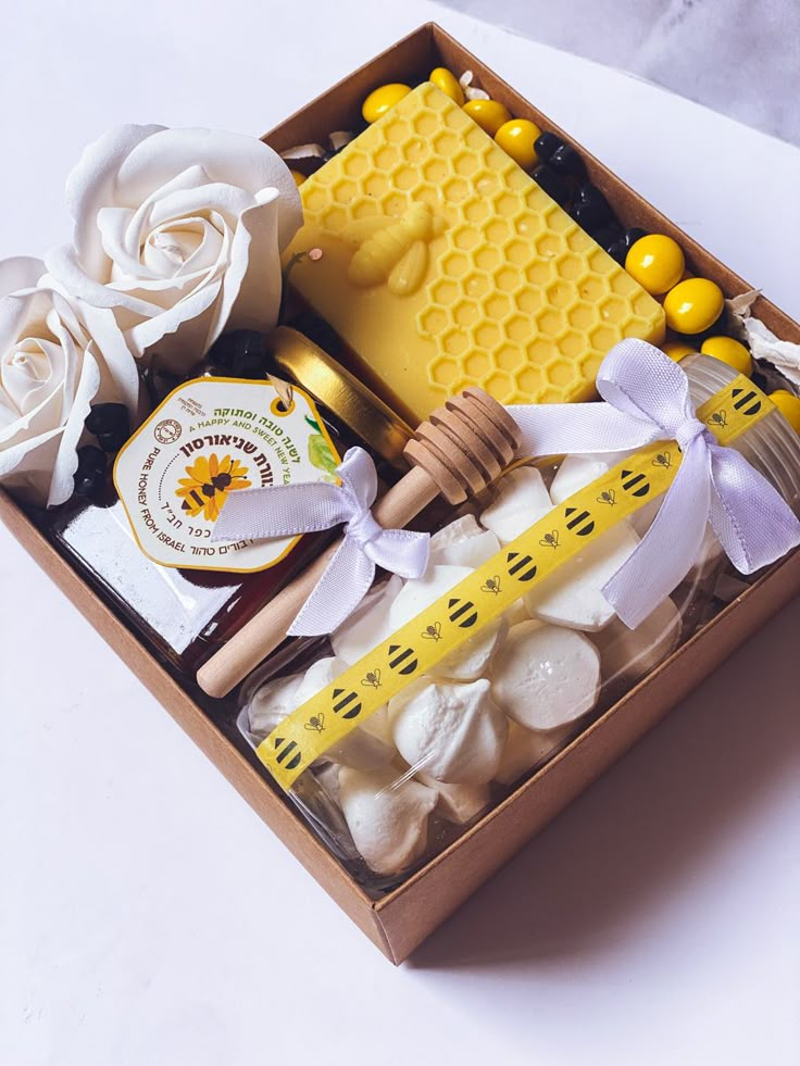 a box filled with lots of different types of candies and honeycombs on top of a table