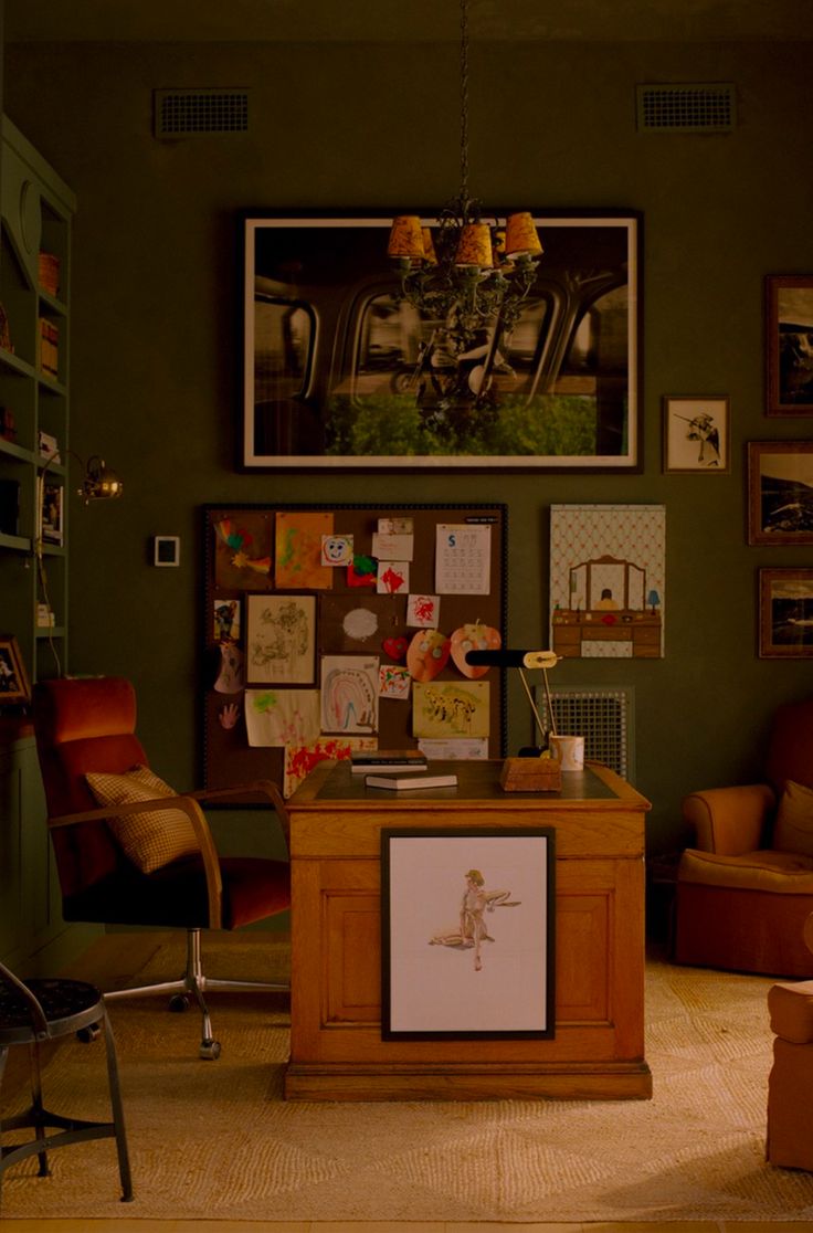 a living room filled with lots of furniture and pictures on the wall next to a chair