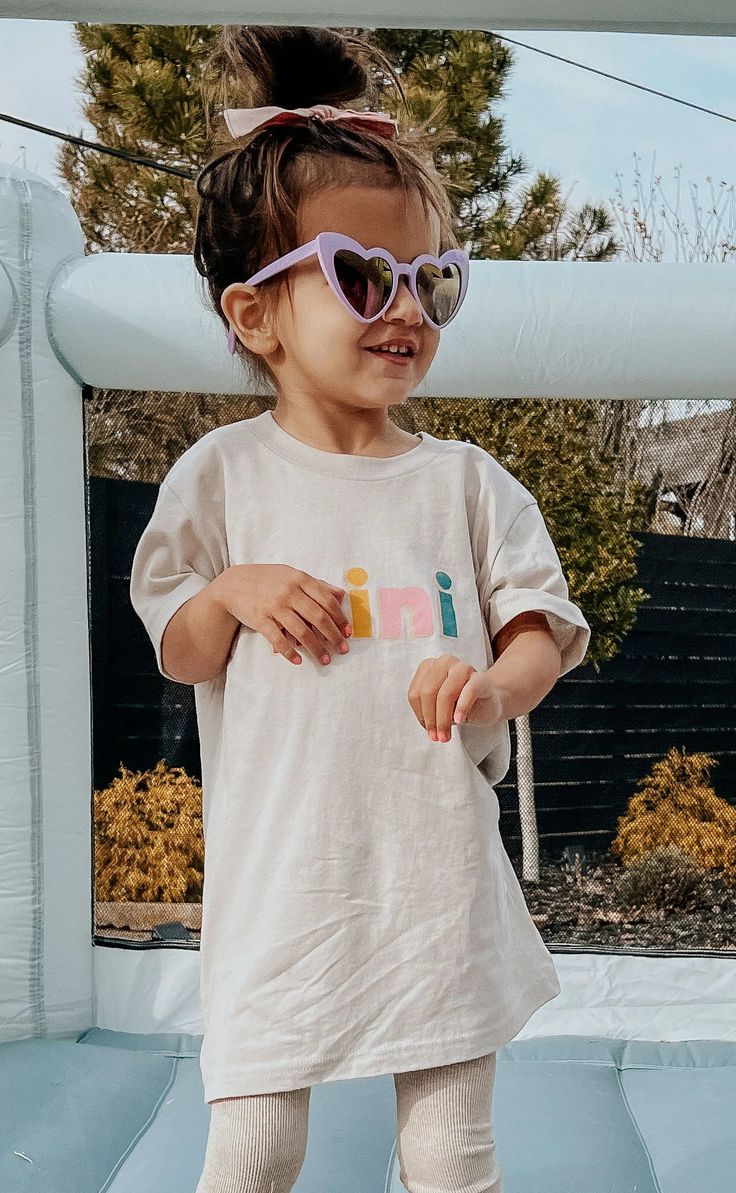 Mad this for mini tee! The mini tee features block lettering on a cream background. Want to have a matching moment? Grab the mama color block tee. TTS SIZING GUIDE: 2T: 22” bust and 15.25” length 3T: 24” bust and 15.5” length Playful White T-shirt For Everyday, Beige Short Sleeve Tops For Playtime, Cute Cream Tops With Letter Print, Cotton Short Sleeve T-shirt For Playdate, Spring Letter Print T-shirt For Playtime, Fun Cotton T-shirt For Playdate, Cream Short Sleeve Top For Playtime, Trendy Letter Print Tops For Playtime, Playful Short Sleeve T-shirt For Playdate