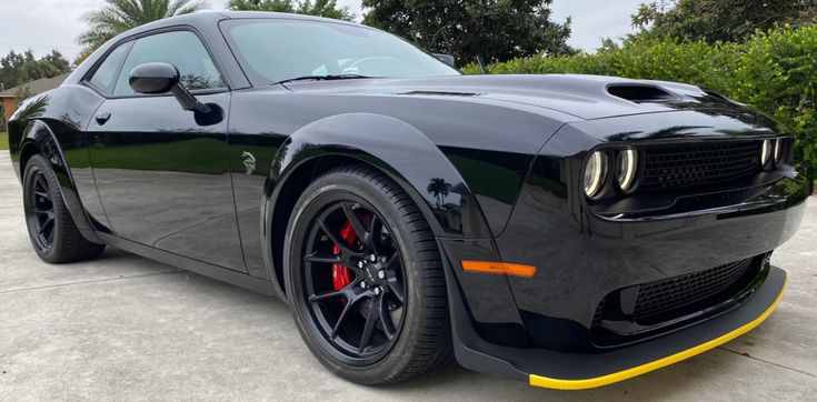 the front end of a black sports car