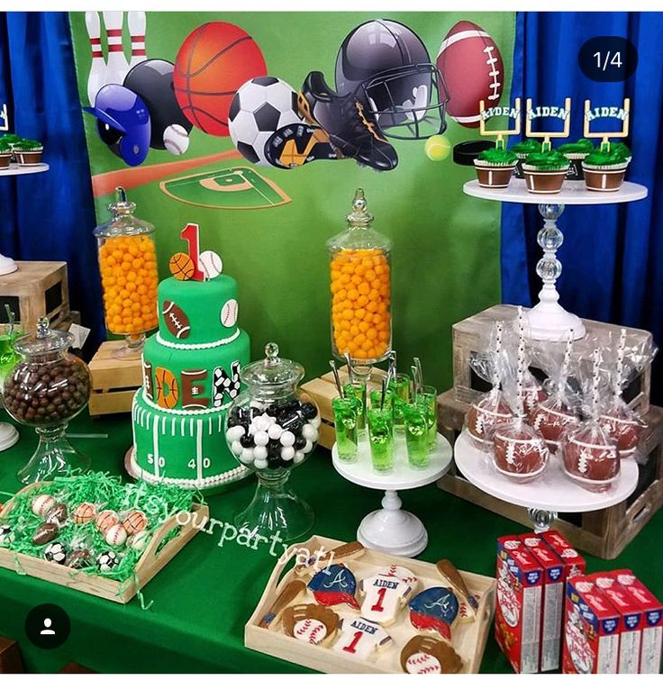 a sports themed dessert table with green and white cakes, candy bars, and candies