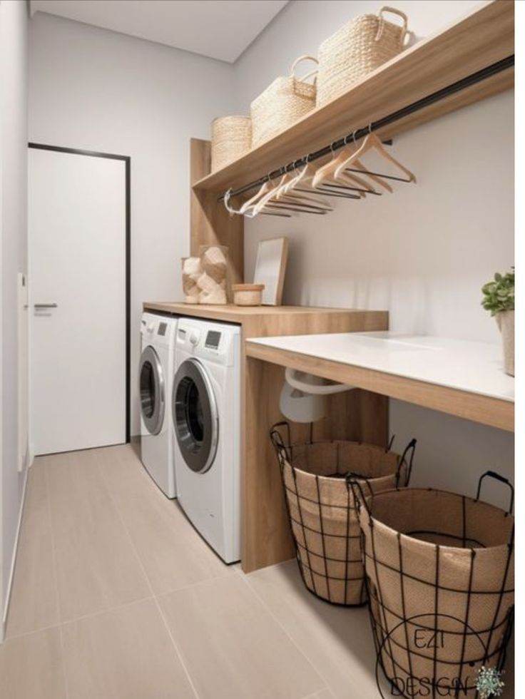 a washer and dryer in a small room with baskets on the shelf next to it