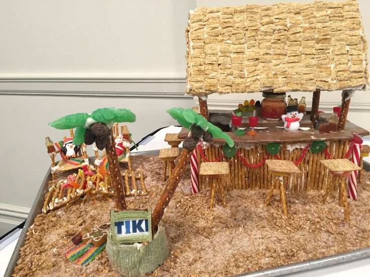 a table with chairs, palm trees and other decorations on top of it in the shape of a boat