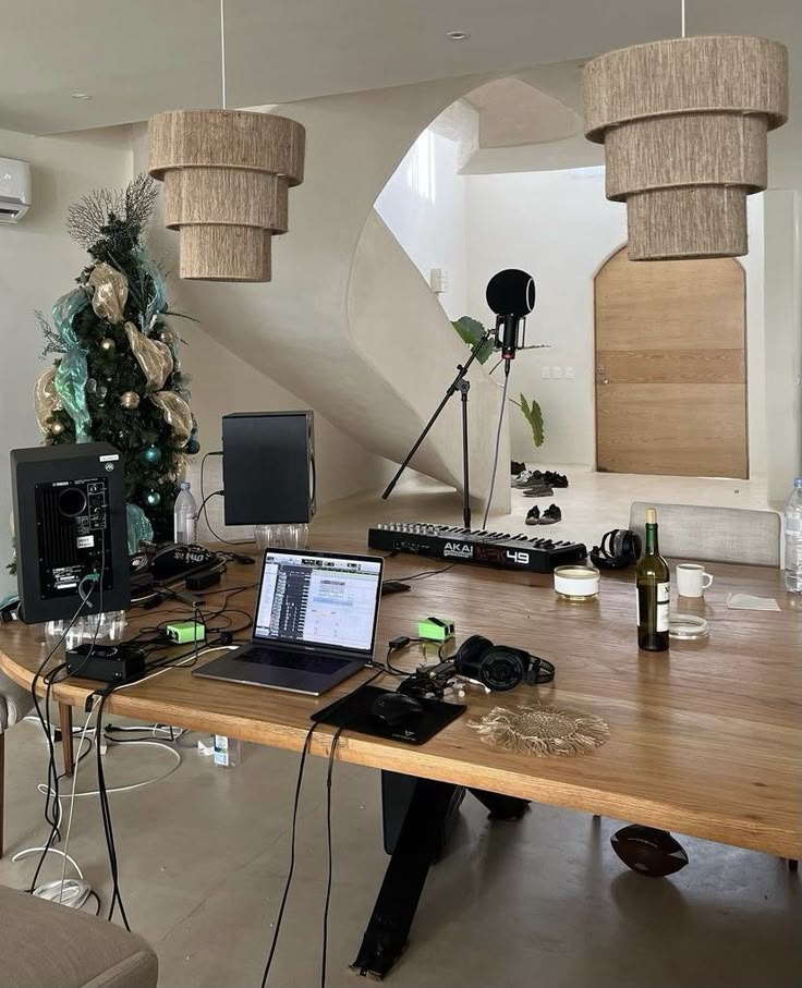 a laptop computer sitting on top of a wooden table in front of a christmas tree