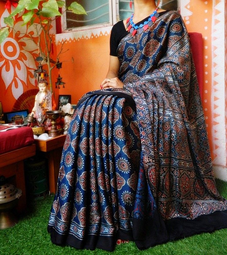 Ajrakh-Printed Silk Saree with Tassels - Sarees Women Apparel | World Art Community Ajrak Saree Blouse Designs, Ajrakh Prints Saree, Ajrakh Sarees Online, Ajrakh Saree Blouse Designs, Ajrak Saree, Khadi Sarees, Ajrakh Sarees, Ajrak Print, Trending Sarees