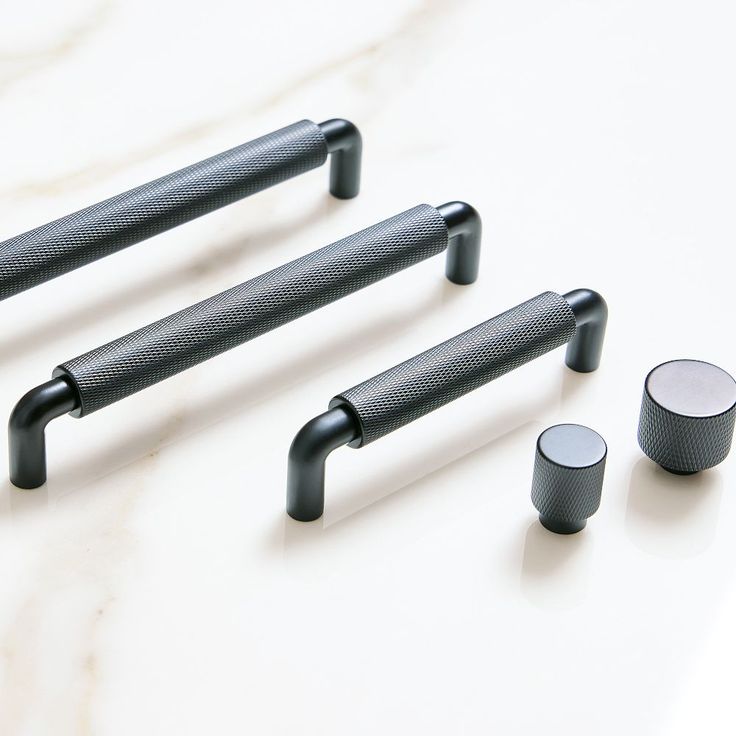 four different types of handles and knobs on a white surface