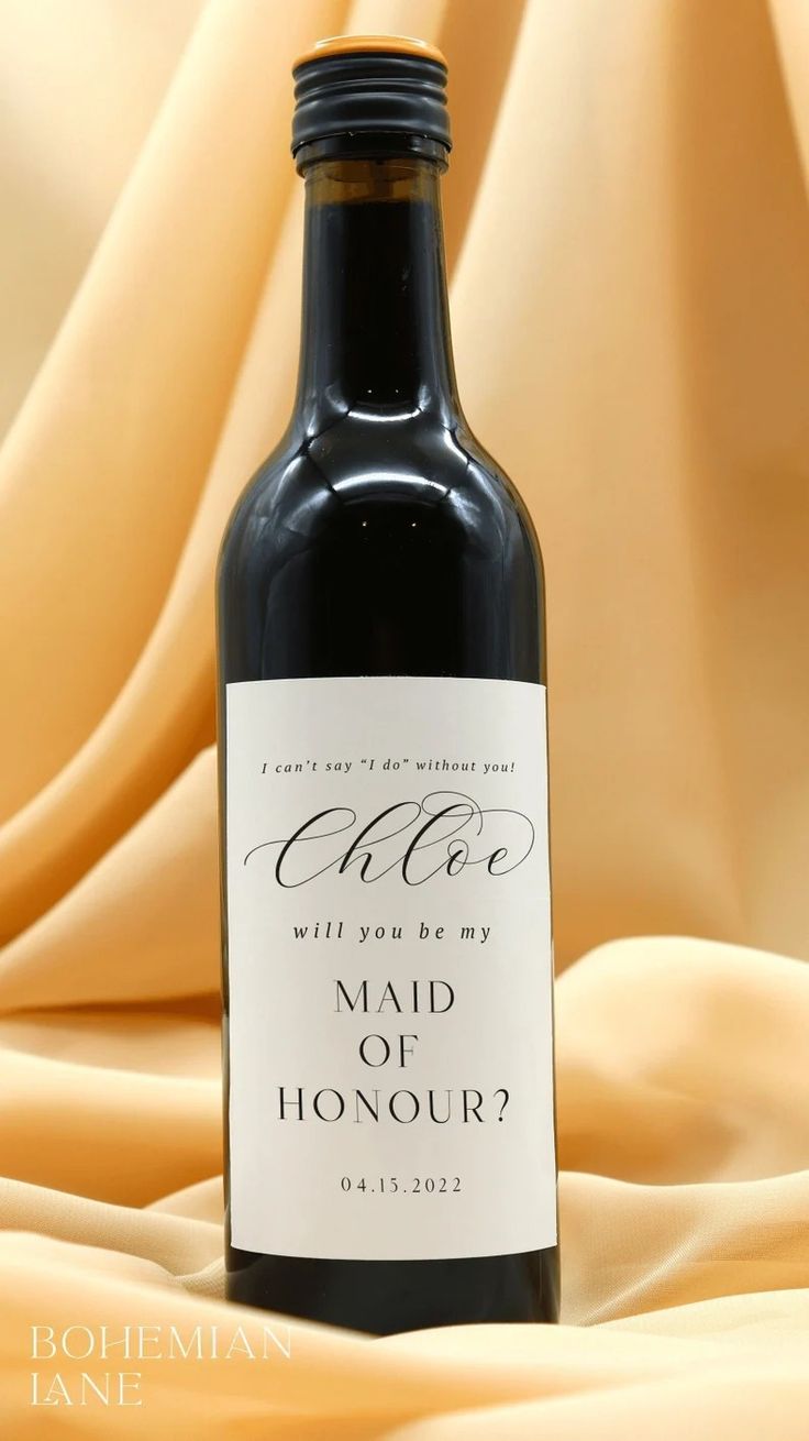 a bottle of wine with a label that says, who will you be my maid of honour?