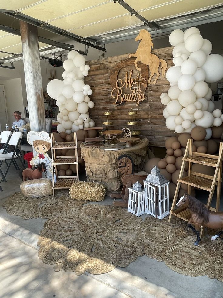 balloons and chairs are set up in front of the entrance to a horse themed birthday party