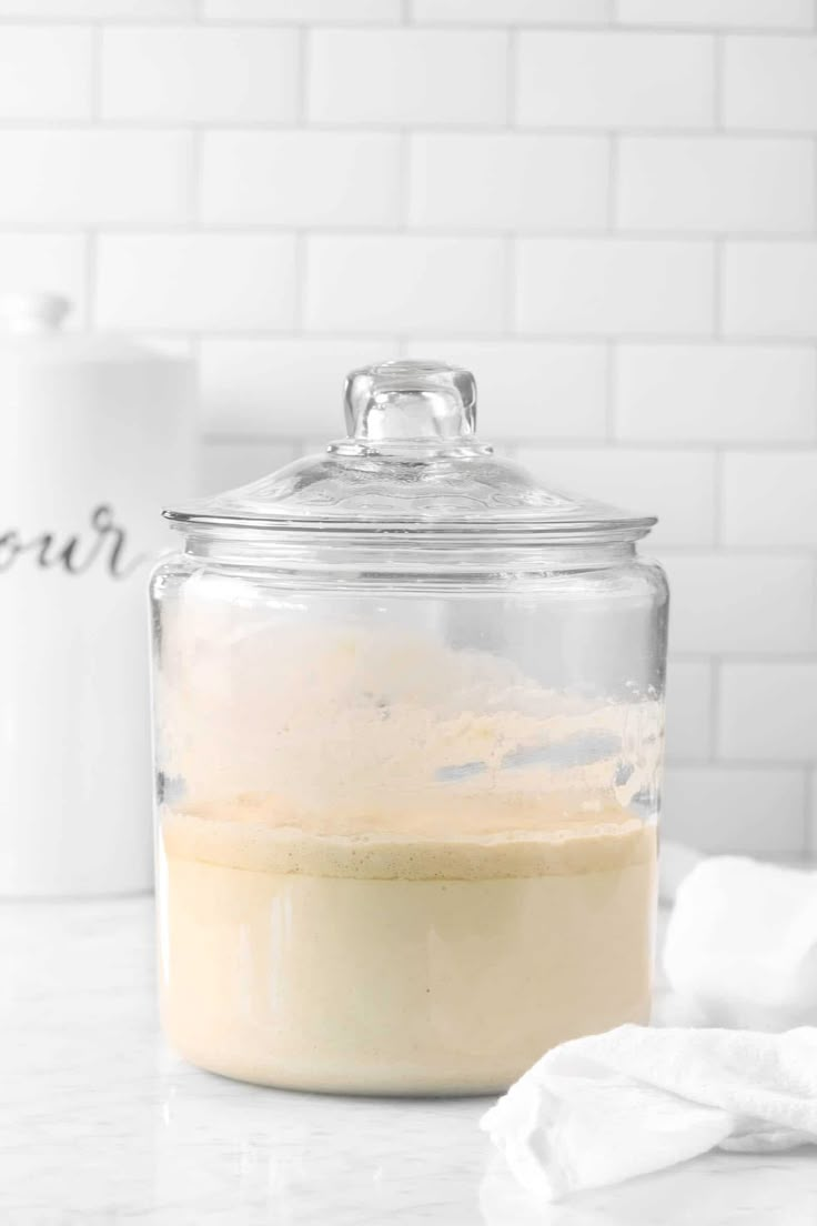 a glass jar filled with liquid sitting on top of a counter