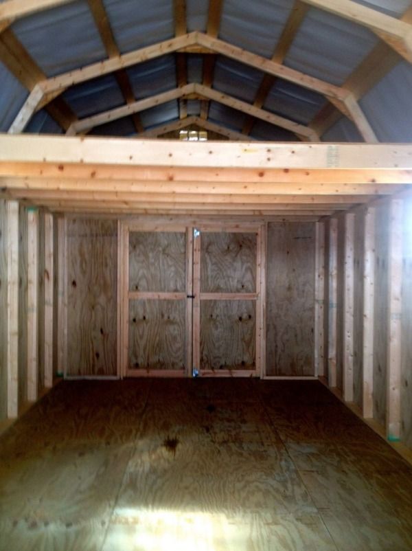 an empty room with wooden walls and wood flooring