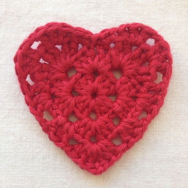 a red crocheted heart on a white background