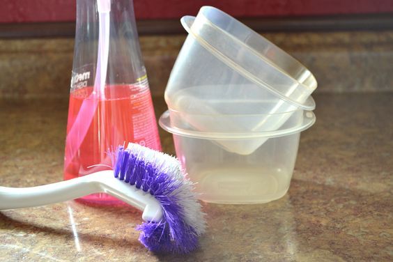 a toothbrush sitting on top of a counter next to containers with liquid in them