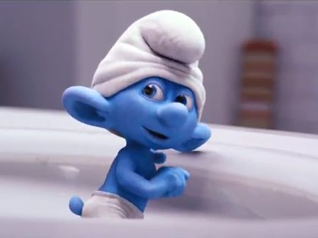 the smurf is wearing a white towel on his head and leaning against a sink