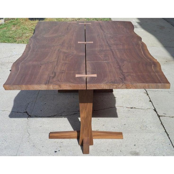 a wooden table sitting on top of a sidewalk