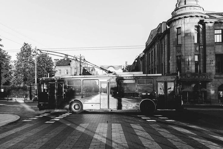 a black and white photo of a bus on the street