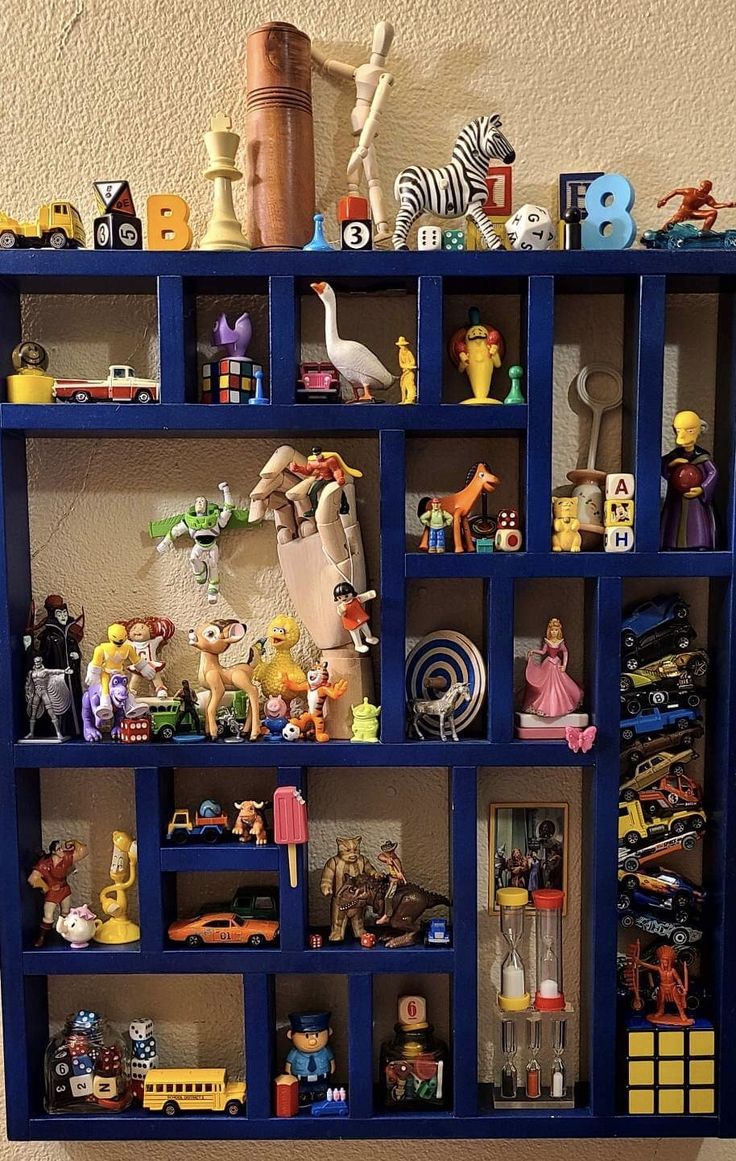 a blue shelf filled with lots of toy figurines