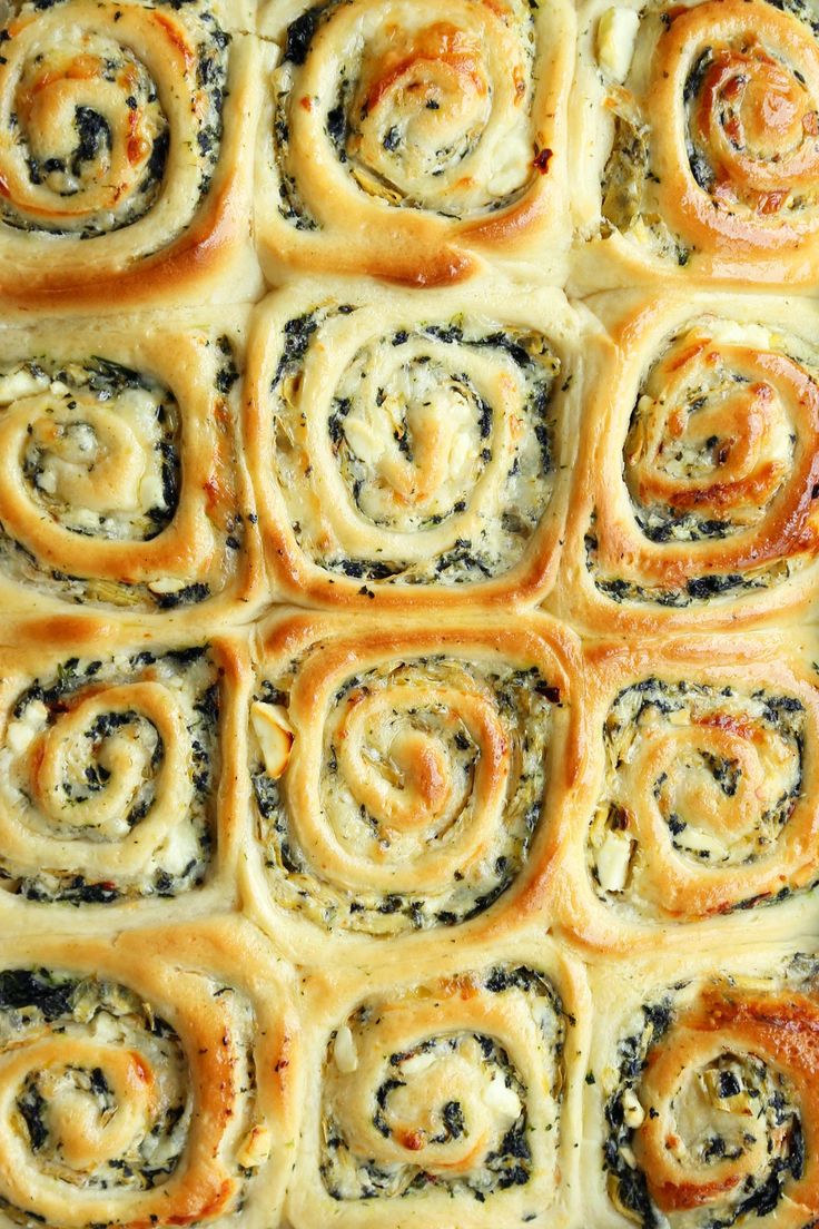 a close up of some food in a pan with spinach and cheese on it