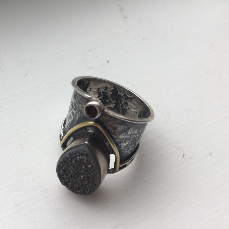 Artisan Crafted Grey Druzy, Sterling Silver And 14k Gold Ring Is Nwot! In Brand New Unworn Condition. Artisan Crafted So Didn’t Come With Tags. Sterling Silver Etched Cigar Band With Tear Drop Shaped Grey Druzy And 14k Gold Accents. Tiny Round Garnet Below The Druzy. It's So Hard To Highlight The Sparkle Of The Grey Druzy In These Photos; Didn't Help That It Was A Cloudy Old Day. Size 6: Just Under One Inch Wide At Its Widest Point; Band Is Thicker In Front Than The Back. Retailed For $136. Heirloom Sterling Silver Hand Cast Jewelry, Heirloom Hand Cast Sterling Silver Jewelry, Hand Cast Sterling Silver Wide Band Jewelry, Artisan One Of A Kind Open Ring Jewelry, One Of A Kind Open Ring For Anniversary, Artisan One-of-a-kind Open Ring Jewelry, Artisan Ring With Oxidized Finish, Unique Hand Forged Wide Band Jewelry, Hand Forged Fusion Ring