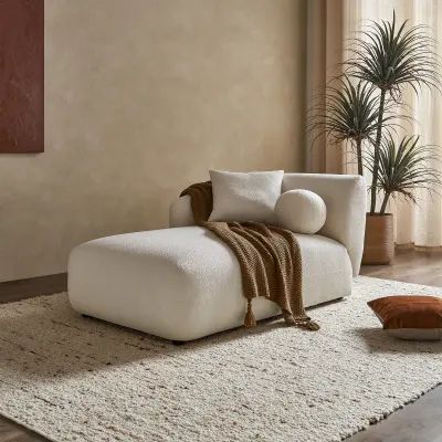 a white couch sitting on top of a rug in a living room