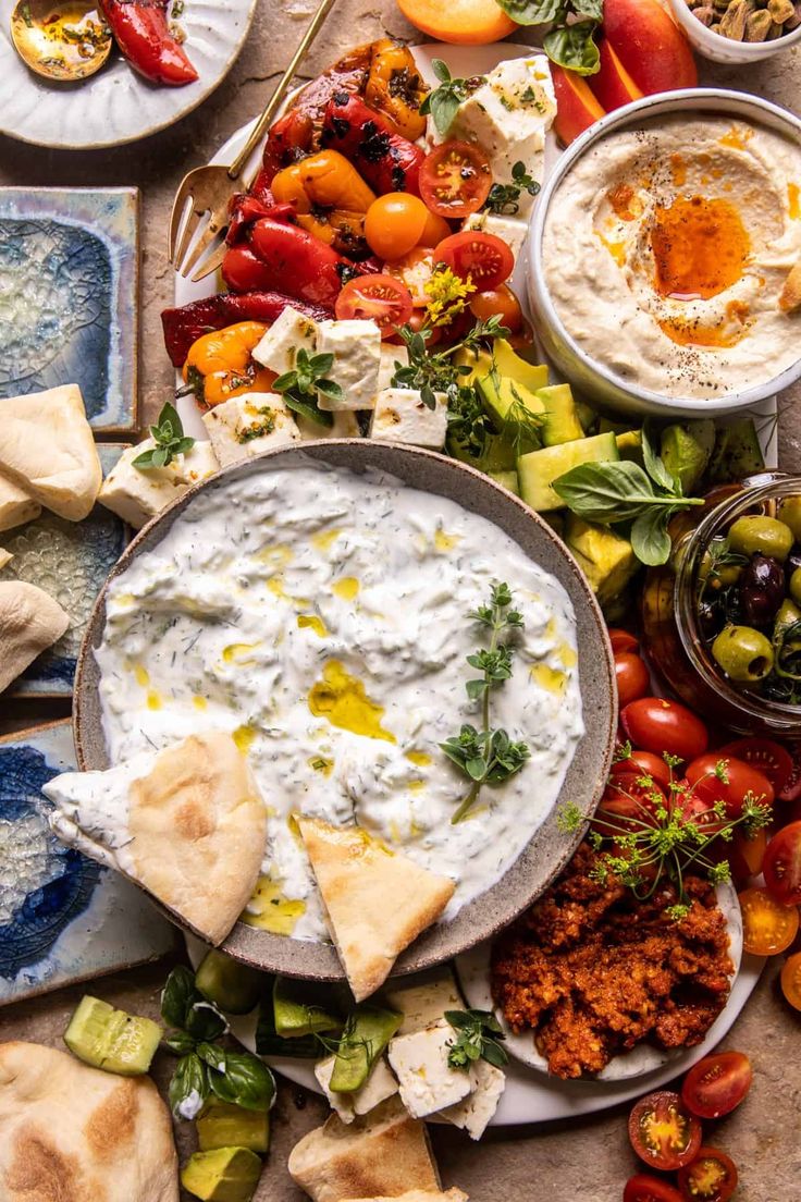 a table topped with plates and bowls filled with different types of food