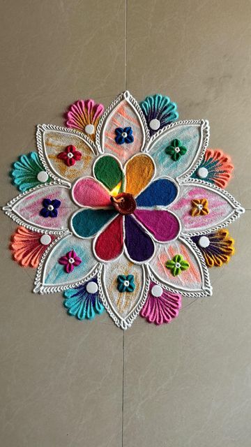 a multicolored flower is hanging on the wall