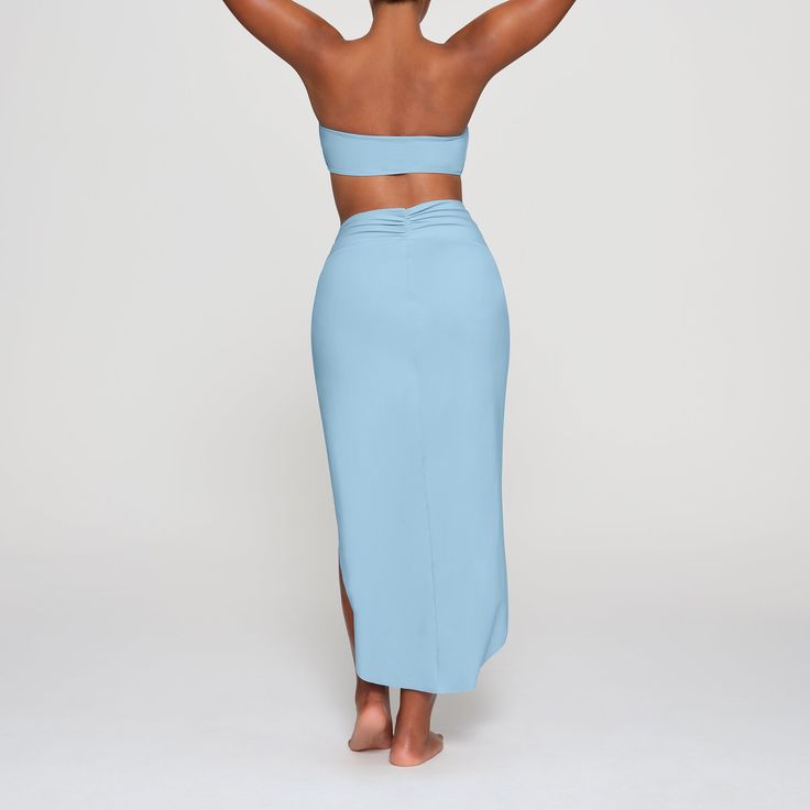 The signature SKIMS bandeau top, now available as a classic strapless swim style. Perfect for the beach and beyond, this top also features a detachable halter strap for additional styling options. Fits true to size. | SKIMS Bandeau Bikini Top | Blue | XS | Swim Stretch Tube Top With Built-in Bra For Vacation, Summer Bandeau Tankini With Built-in Bra, Vacation Bandeau Tube Top With Built-in Bra, Beachwear Tube Top With Built-in Bra For Vacation, Strapless Tankini With Built-in Bra For Beachwear, Strapless Tankini With Built-in Bra For Beach Season, Summer Tube Top With Built-in Bra For Sunbathing, Seamless Triangle Tube Top For Poolside, Bandeau Tube Top For Pool, Bra-friendly