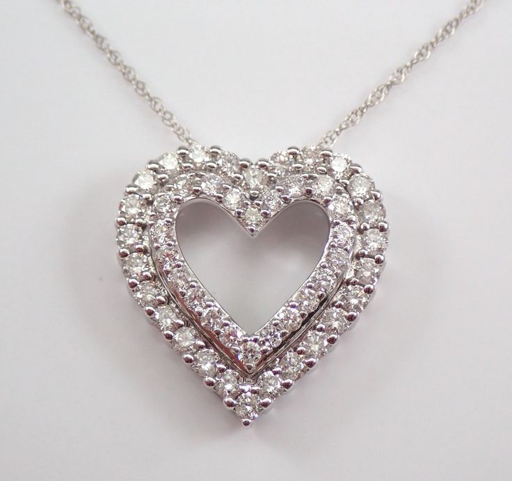 "14K White Gold Diamond Heart Pendant with Chain. This heart is set with forty-eight genuine Round Brilliant Diamonds.  These diamonds are H color, I1 clarity and combine to a total weight of 1.00 carat. The heart measures 22 X 18 mm with the bail and weighs 2.9 grams with the 18\" included chain. The pendant and the chain are both 14K White Gold and accompanied by an appraisal, valued at $2,095.00.  The necklace will be shipped promptly in a gift box. ADDITIONAL REQUESTS If you would like to see more pictures of this item, please let us know and we would be happy to provide them for you. Please contact us with all questions, we are here to help." Diamond Heart Pendant Wedding Jewelry, Heart-shaped Wedding Jewelry With Diamond Accents, White Heart-shaped Diamond Necklace For Formal Occasions, White Heart-shaped Diamond Necklace For Formal Events, White Heart Diamond Necklace For Formal Occasions, Dazzling Heart-shaped Jewelry For Weddings, Diamond Cut Heart Pendant Jewelry For Wedding, Fine Jewelry Double Heart Wedding Jewelry, Heart-shaped Diamond Cut Wedding Jewelry