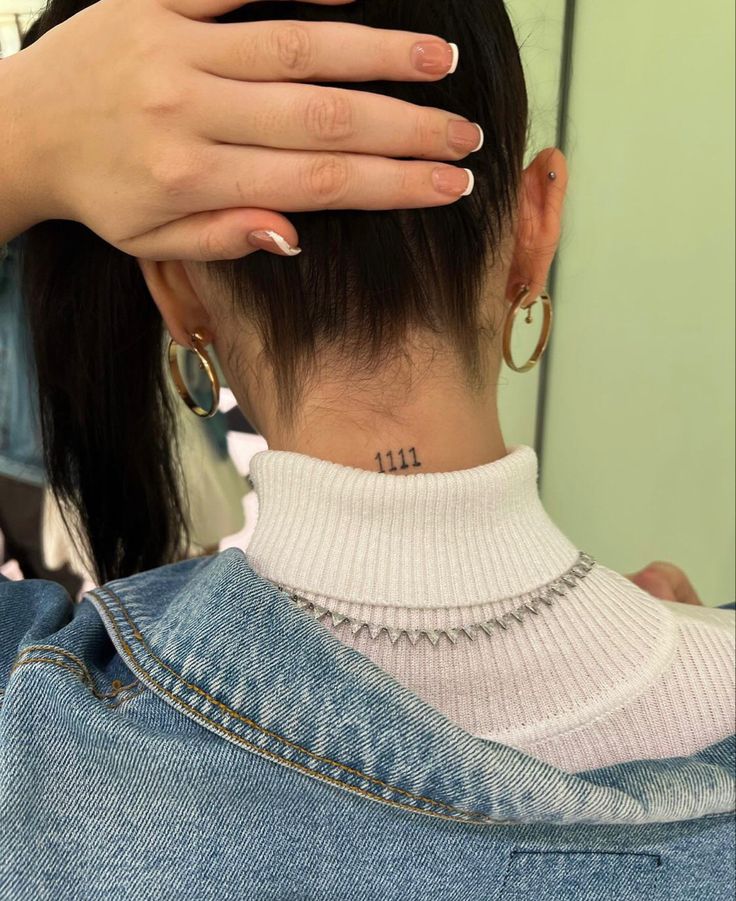 the back of a woman's head with her hands on top of her head