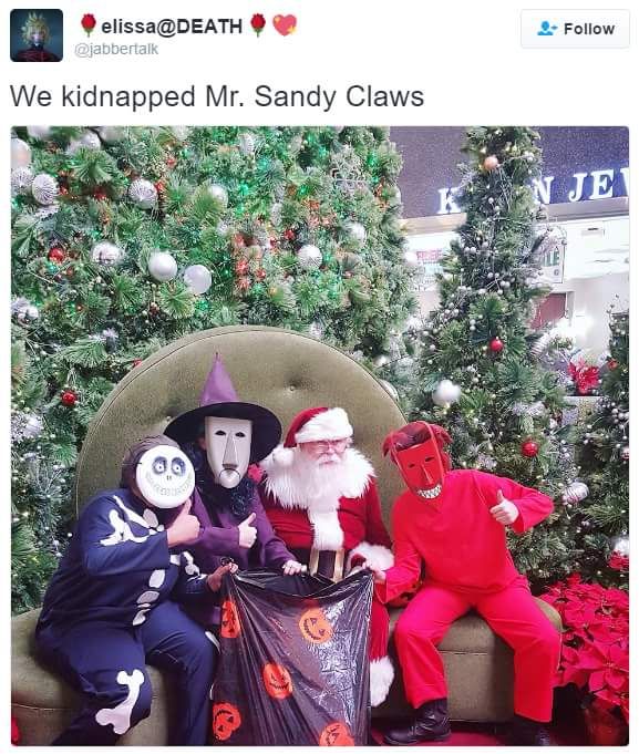 two people dressed as characters sitting in front of christmas trees