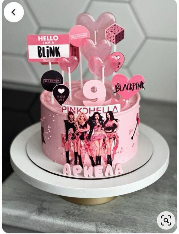 there is a pink cake decorated with hearts and stickers on the top it says hello blink