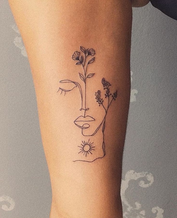 a woman's leg with a flower tattoo on the left side of her thigh