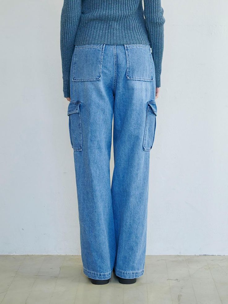 This is a denim version of the trendy cargo pant style. The pants have a straight fit that makes your legs look longer, and there are outside pockets on both sides to create a three-dimensional feel. It's great for mixing and matching with feminine items, and it's also good for styling with casual items like hoodies. - Practical with pockets on the front and back- Opening and closing with canton button and zipper- Can be styled with a belt- Branded leather patch on the back of the waist Spring Utility Cargo Jeans Straight Leg, Spring Utility Straight Leg Cargo Jeans, Utility Cargo Jeans Straight Leg For Spring, Spring Straight Cargo Jeans With Multiple Pockets, Trendy Straight Leg Cargo Pants With Patch Pockets, Baggy Utility Cargo Jeans For Workwear, Trendy Cargo Pants With Patch Pockets And Straight Leg, Urban Straight Leg Cargo Jeans With Patch Pockets, Urban Denim Blue Cargo Pants With Pockets