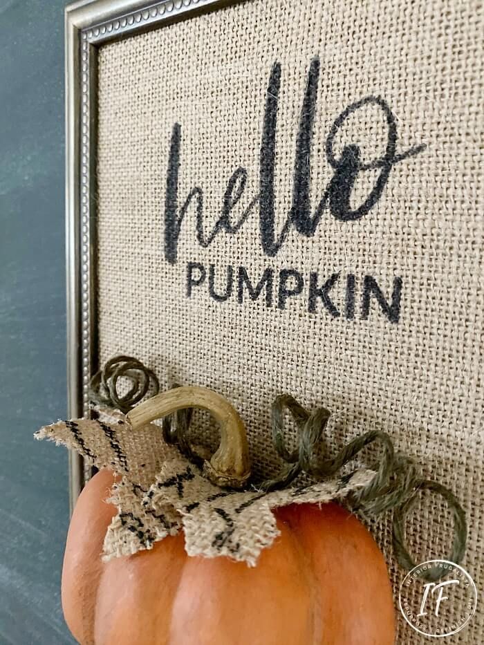 a pumpkin sitting on top of a table next to a burlocked sign