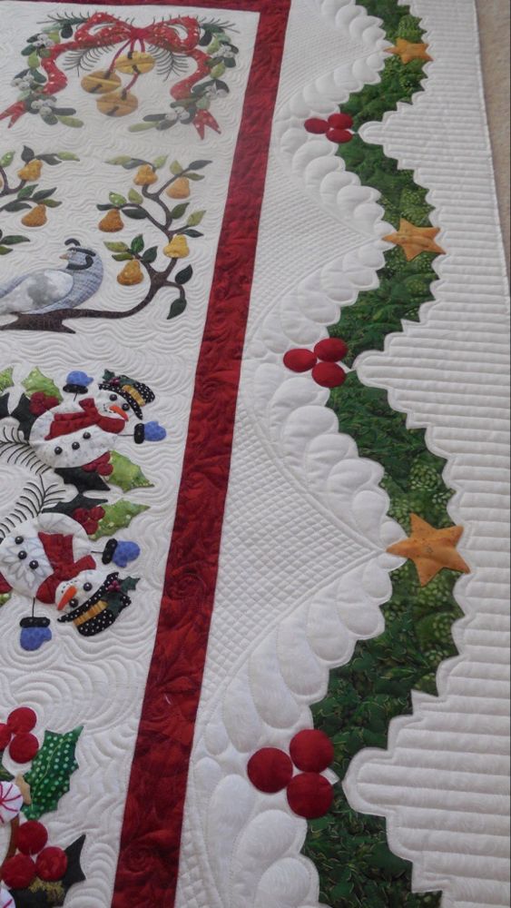 a quilted table runner with christmas decorations on it