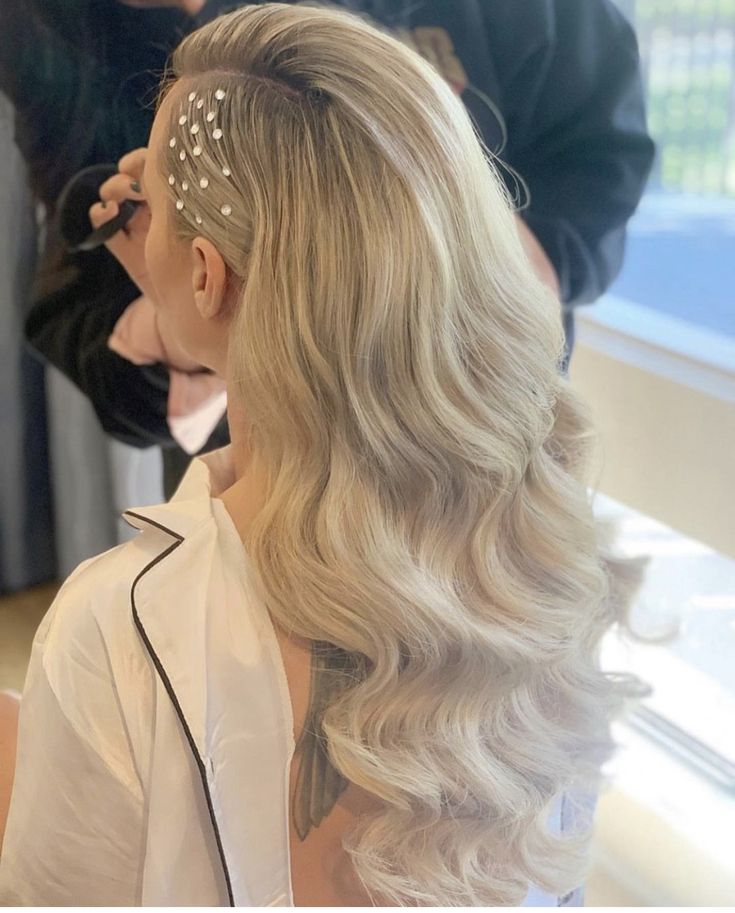 a woman is getting her hair done at the salon