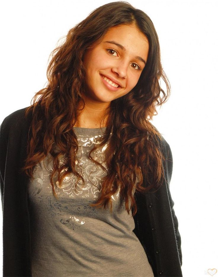 a young woman is posing for the camera with long hair and wearing a gray shirt