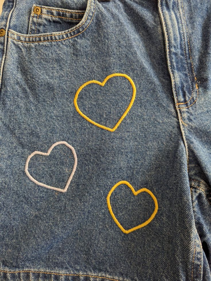 Original Heart Shorts by Sensible Slacks. Reworked denim shorts with yellow and blue hearts embroidered all over. Embroidered Yellow Cotton Bottoms, Yellow Embroidered Cotton Bottoms, Shorts With Heart Pockets, Blue Embroidered Cotton Shorts, Embroidered Denim Blue Shorts, Word Embroidery, Mid-rise Embroidered Denim Shorts, Floral Embroidered Denim Cutoff Shorts, Heart Shorts