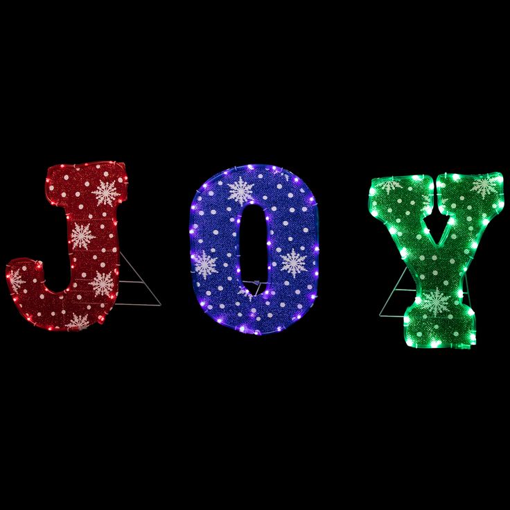 the word joy spelled out with christmas lights and snowflakes on it's sides