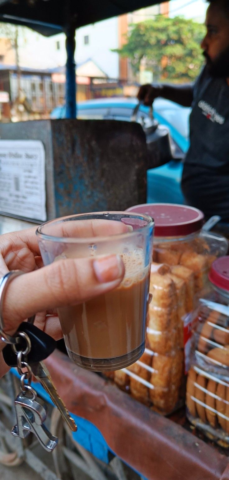 a person holding up a glass with something in it