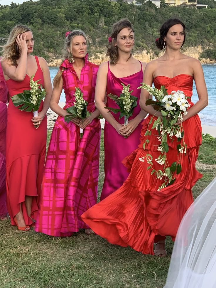 the bridesmaids are all dressed in bright red dresses