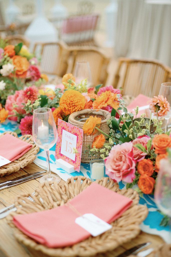 the table is set with flowers and place settings